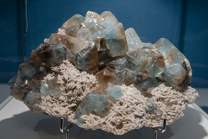 Cluster of bicolor topaz crystals on cleavelandite from Volodarsk, Ukraine