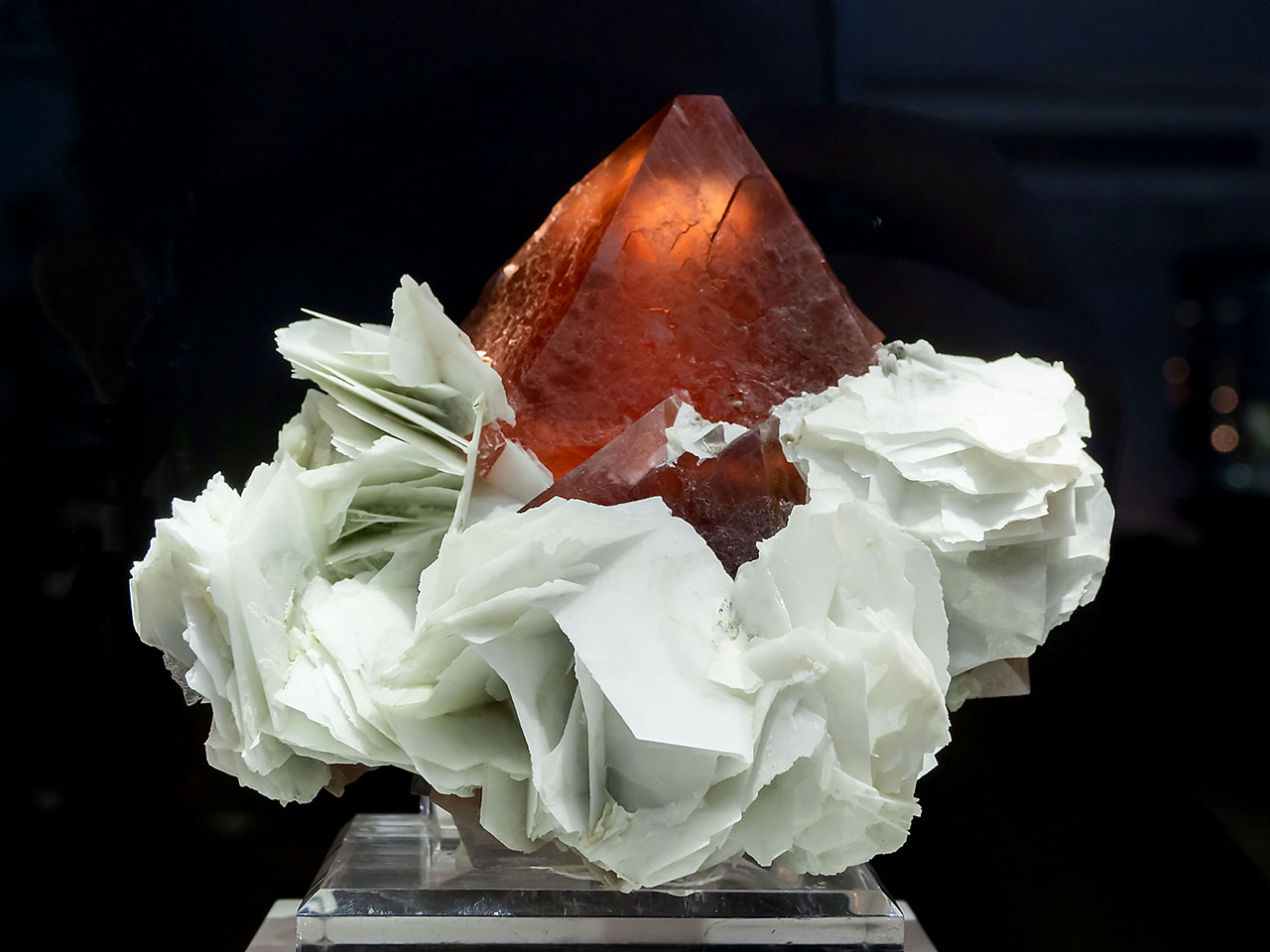 Perfect and huge red fluorite octahedral crystal sitting on the paper calcite from Huanggangliang Mine, Inner Mongolia, China