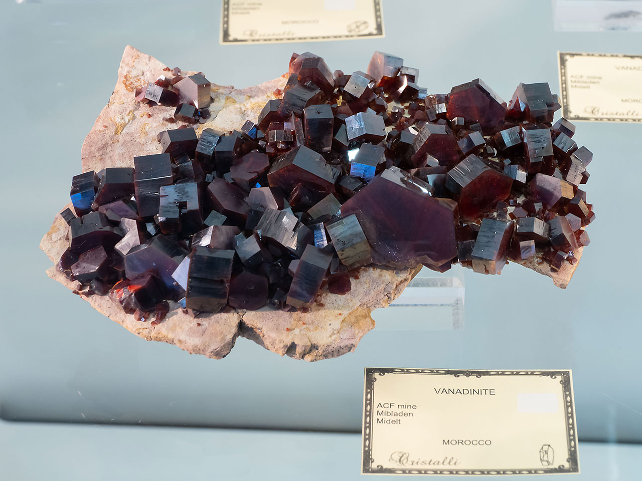 Dark colored vanadinite crystal cluster from Mibladen, Morocco