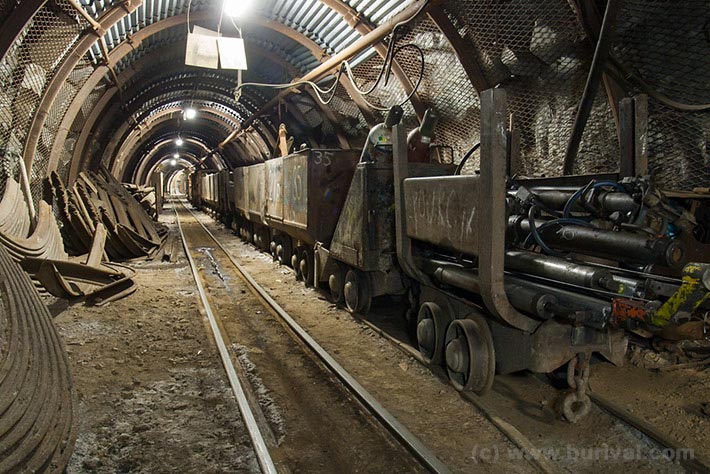 Underground service adit with drilling tools and mine carts