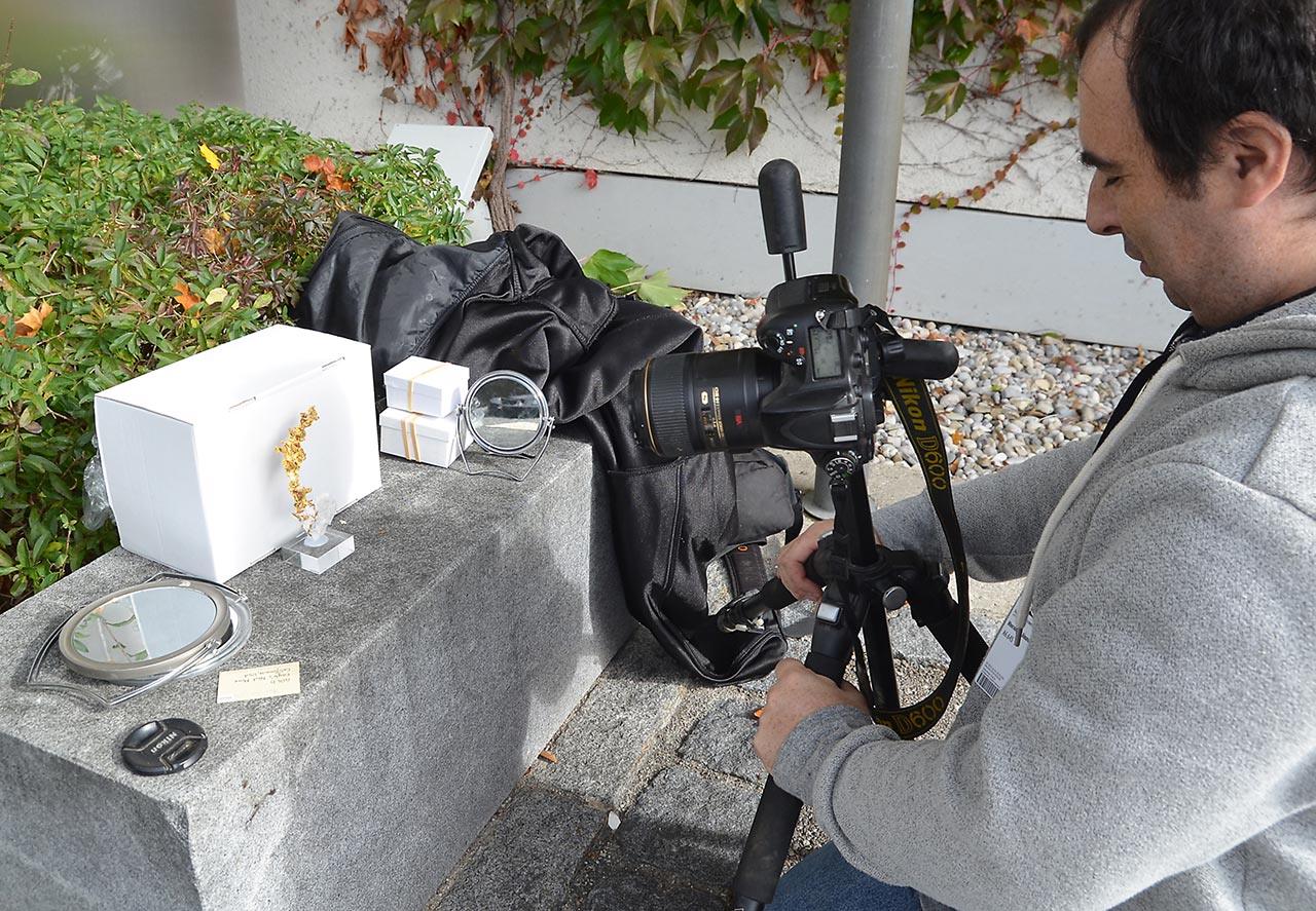 Albert Russ photographing mineral specimens in the yard at Munich show