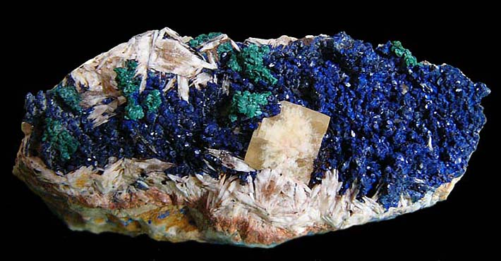 Complex mineral specimen with pink baryte, blue azurite green malachite and yellow fuorite from Aouli, Morocco