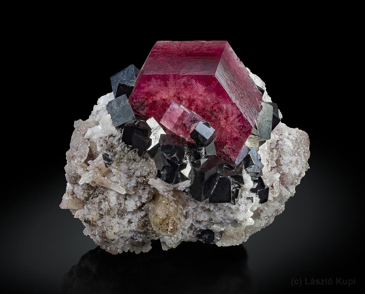 Excellent red beryl (bixbite) crystal with black bixbyite crystals and pale topaz from Searl Canyon, Red Beryl Claim, Juab Co., Utah, USA