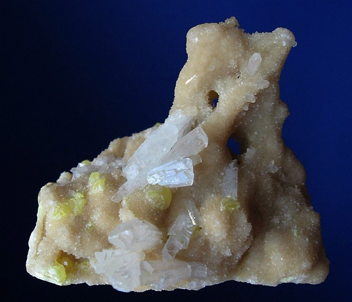 Cluster of big white celestine crystals on matrix consisting of tiny aragonite crystals and yellow sulphur from Tarnobrzeg in Poland