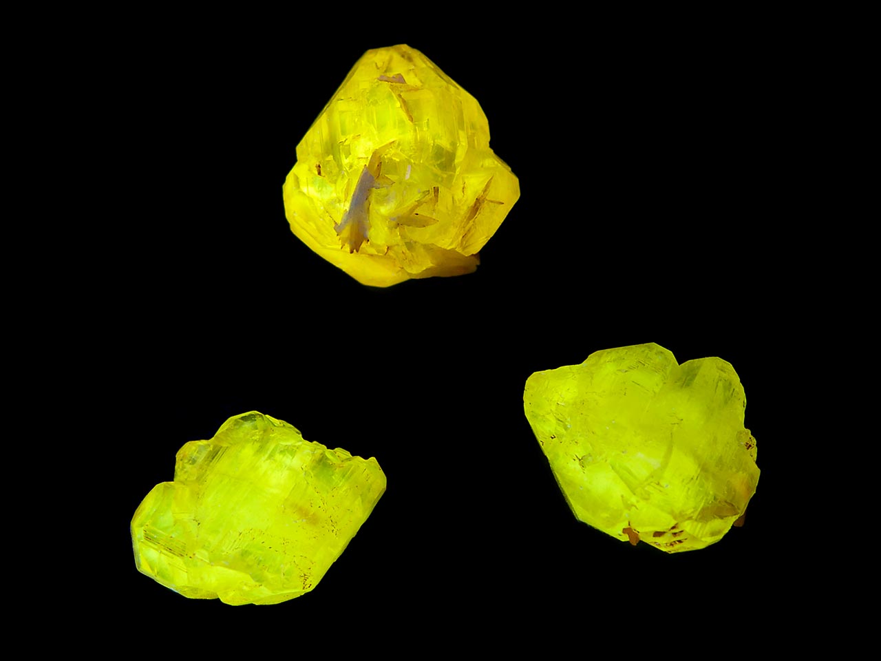 Cerussite crystals from Mibladen, Morocco showing bright yellow fluorescence in shortwave UV light