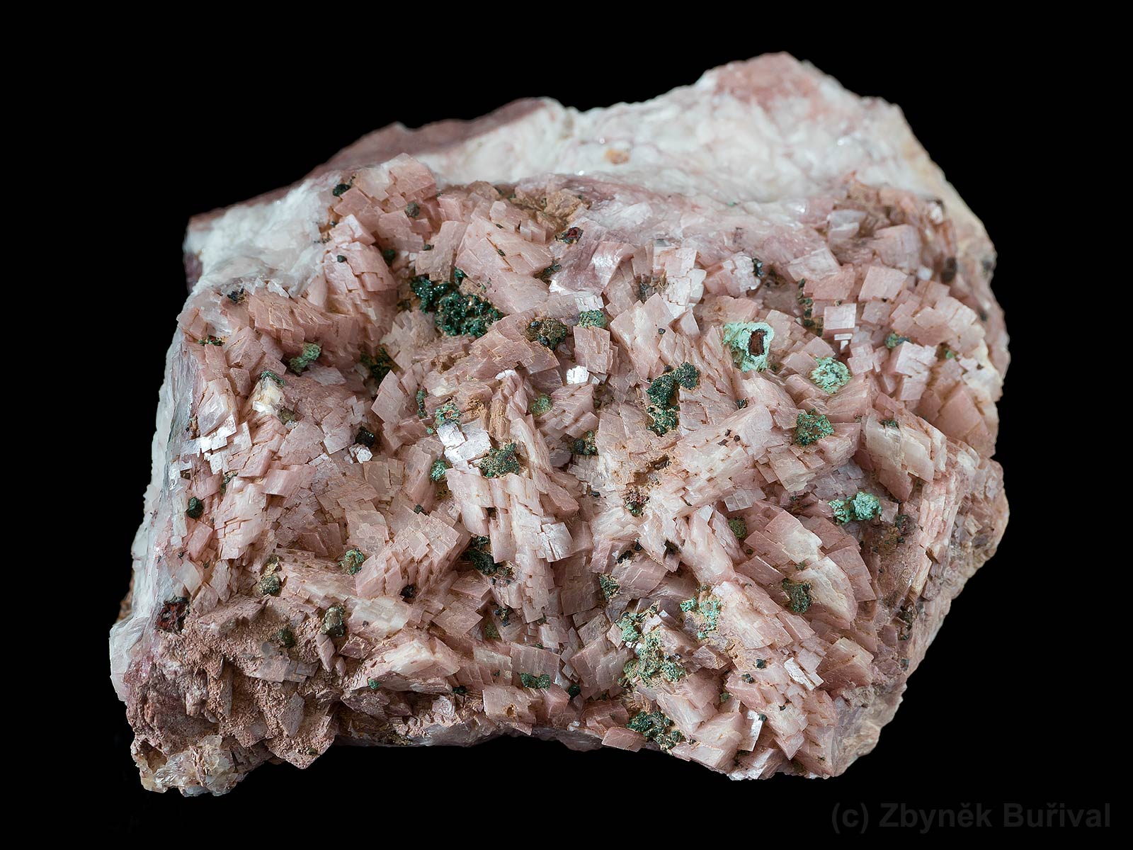 Cluster of pink dolomite crystals with tiny crystals of green brochantite from Touissit, Morocco