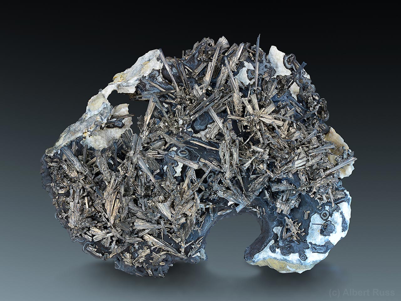 Silver dyscrasite crystals with dark arsenic and white calcite from Příbram, Czech Republic