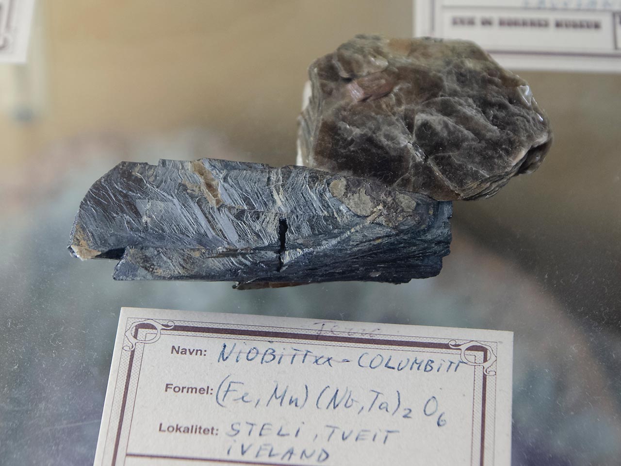 Columbite crystal with mica from Tveit, Iveland, Norway