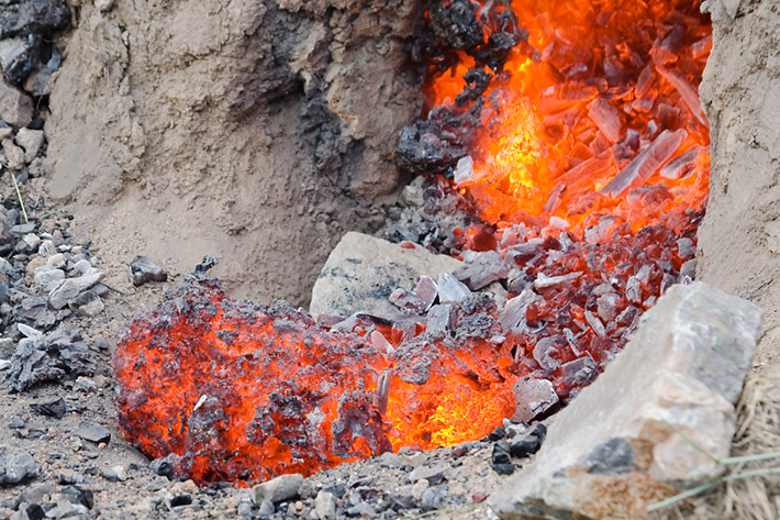 Hot crude iron in front of the ancient smelting furnace