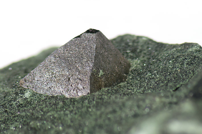 Octahedral magnetite crystal in metamorphosed schist from Binntal, Switzerland