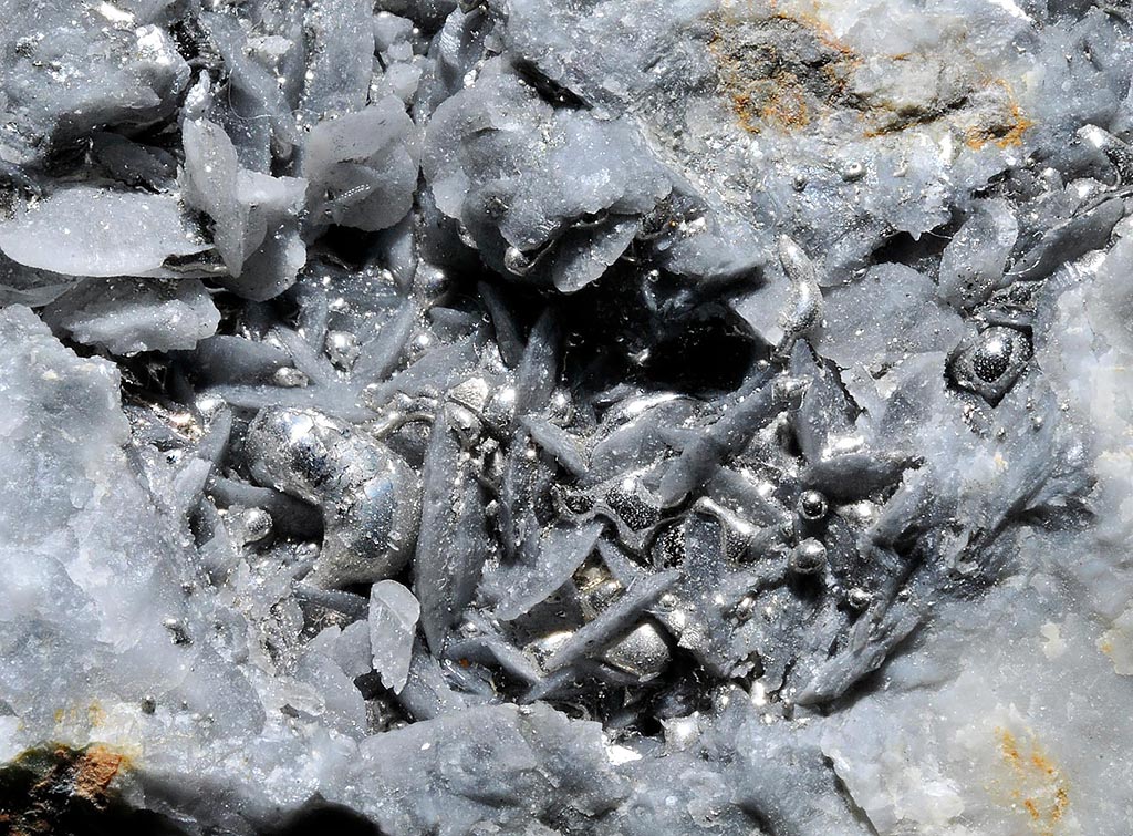 Drops of native mercury on white baryte crystals from El Entredicho Mine in Almadén District, Castile-La-Mancha, Spain