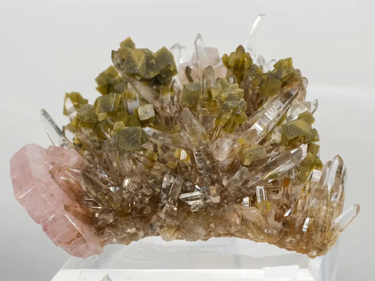 Clear quartz with brown siderite and pink fluorapatite from from Kami Mine, Cochabamba, Bolivia