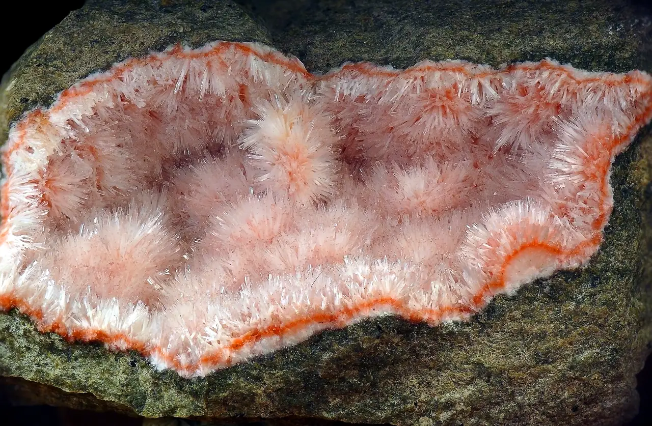 Acicular pink and white natrolite crystals in volcanic vesicle from Mariánská Skála Quarry, Ústí nad Labem, Czech Republic