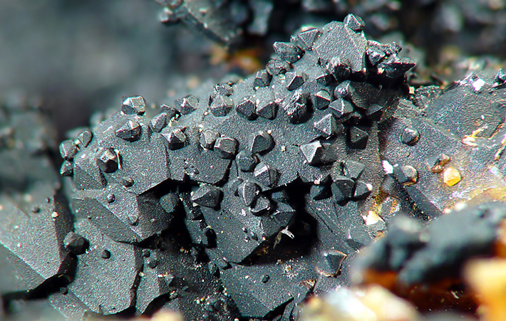 Scheelite crystals on quartz covered by gray manganite from Cinovec, Czech Republic