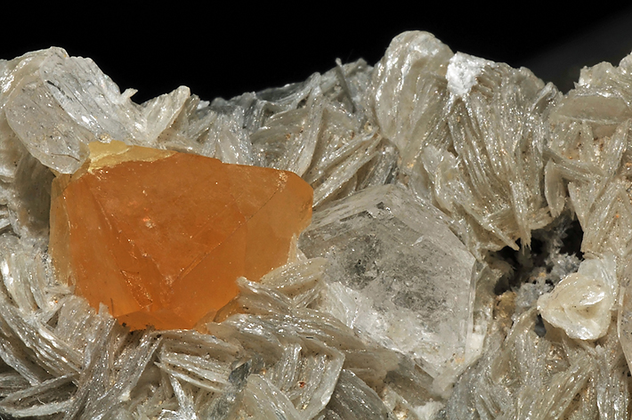 Orange scheelite crystals with pale pink morganite on mica from Pingwu Beryl Mine, Sichuan Province, China