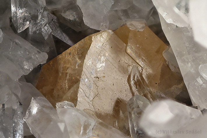 Yellow scheelite crystal on quartz from Obri dul, Czech Republic