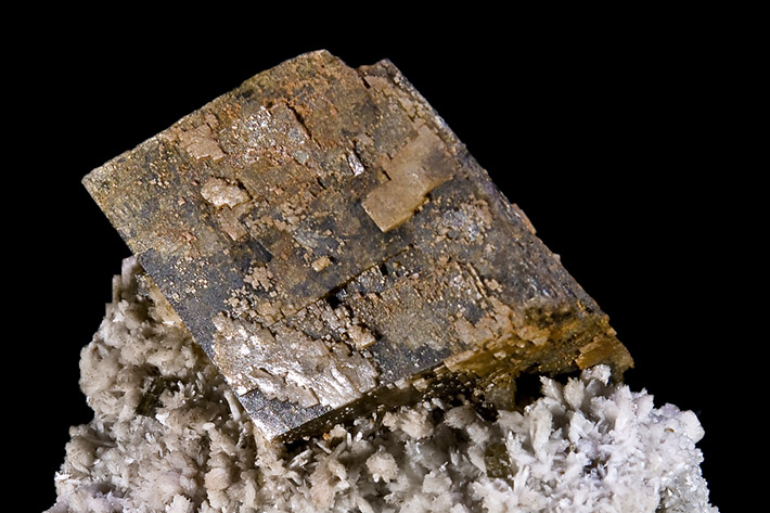 Brown crystal of manganoan siderite on white albite from Poudrette quarry, Mont Saint-Hilaire, Québec, Canada