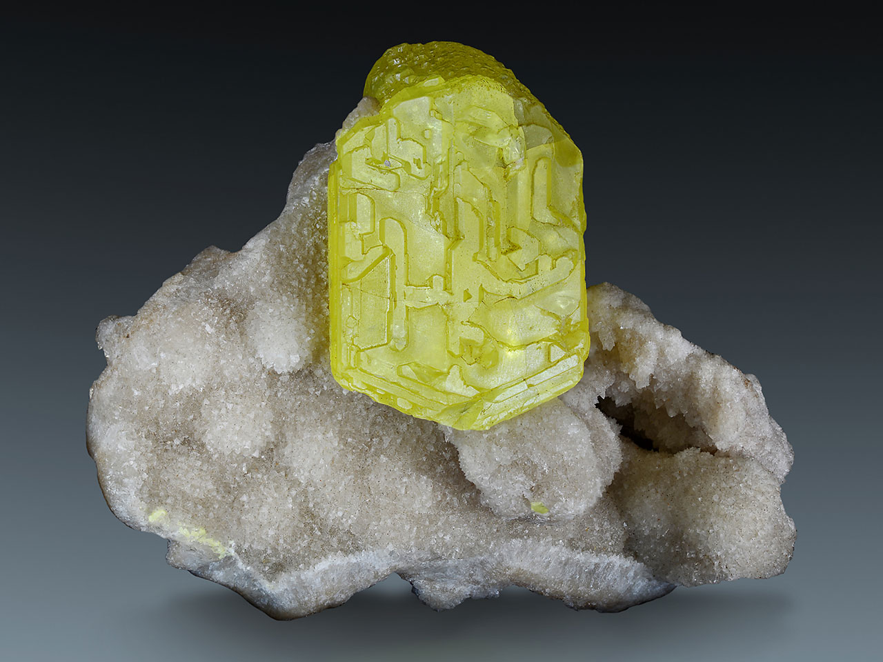 Bright yellow sulphur crystal on white aragonite from Racalmuto,  Agrigento Province, Sicily, Italy. 