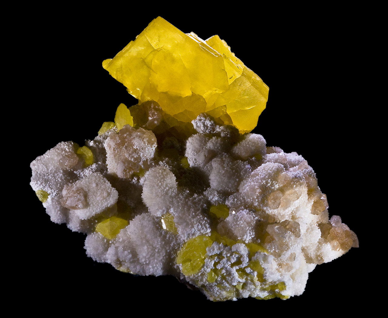 Crystal of native sulphur on calcite matrix from Floristella Mine, Enna Province, Sicily, Italy.