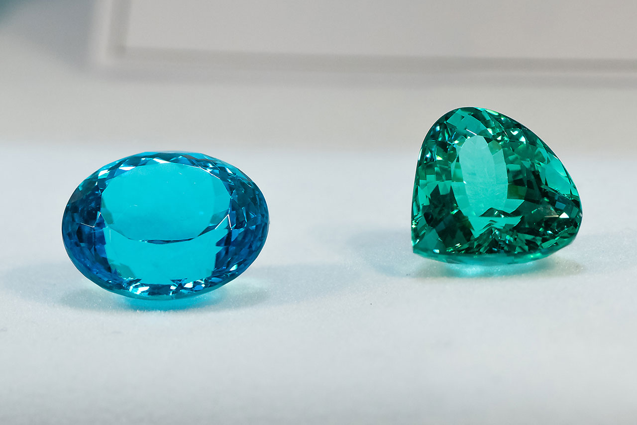 Neon blue and neon green top quality faceted Paraíba tourmalines.