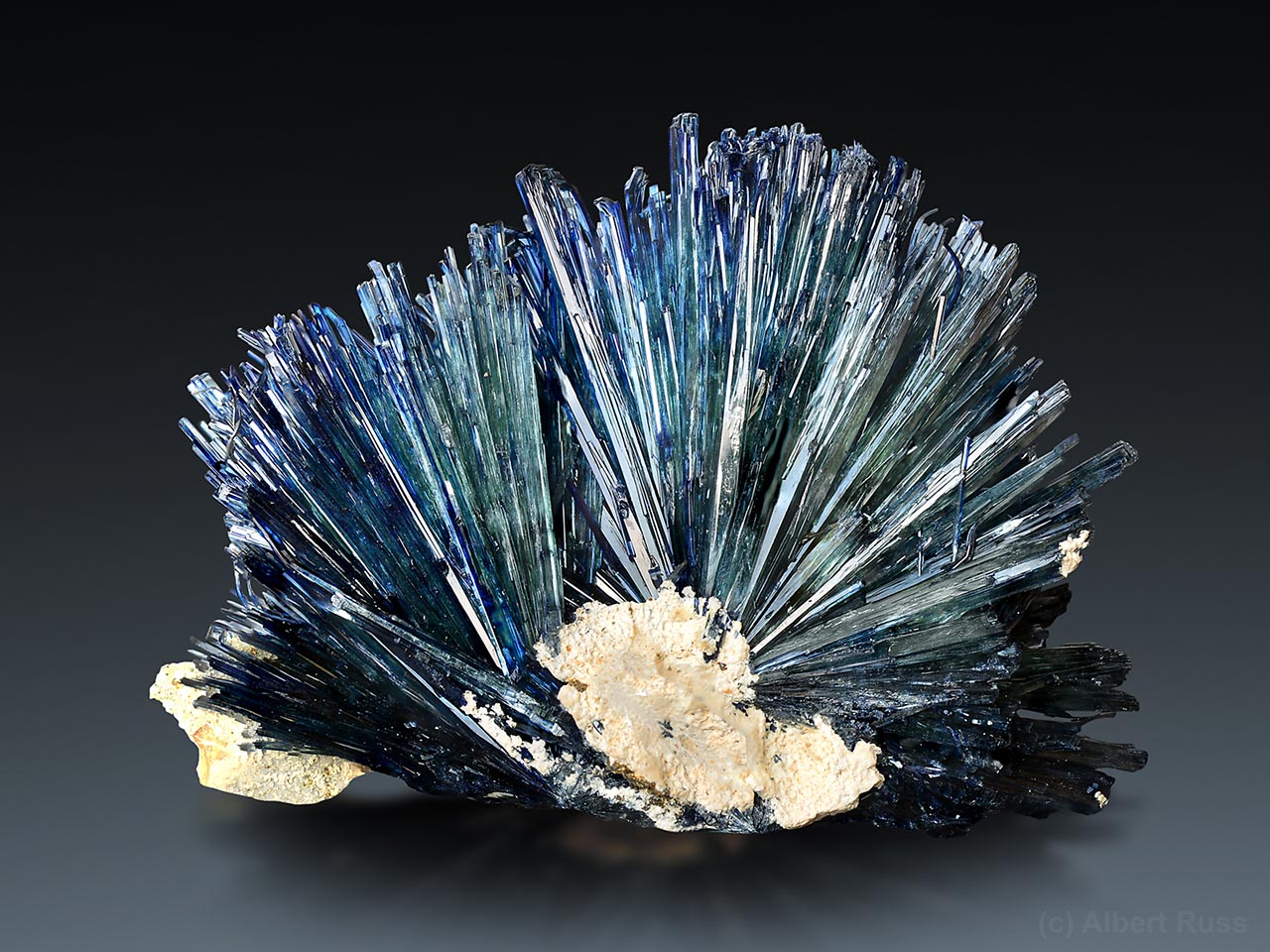 Cluster of thin blue-green vivianite crystals from Bolivia