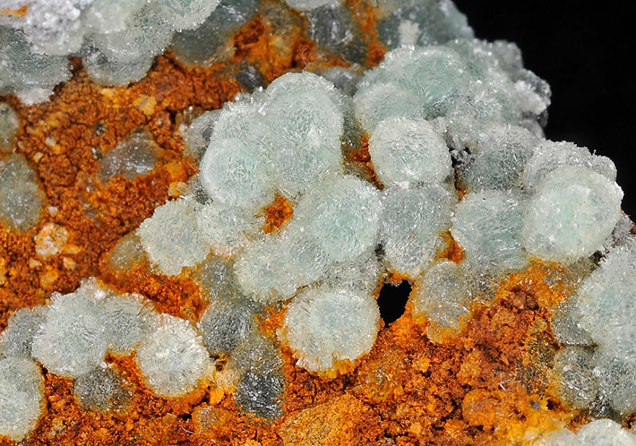 Green wavellite balls with rusty limonite from Magnet Cove, Arkansas, USA