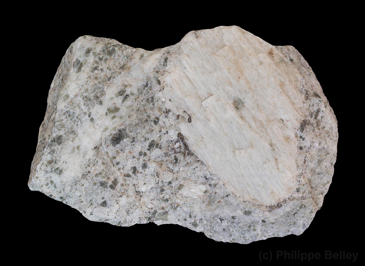 Pale wollastonite crystal in calc-silicate matrix from Highway 50 roadcut, Grenville-Sur-la-Rouge, Québec, Canada