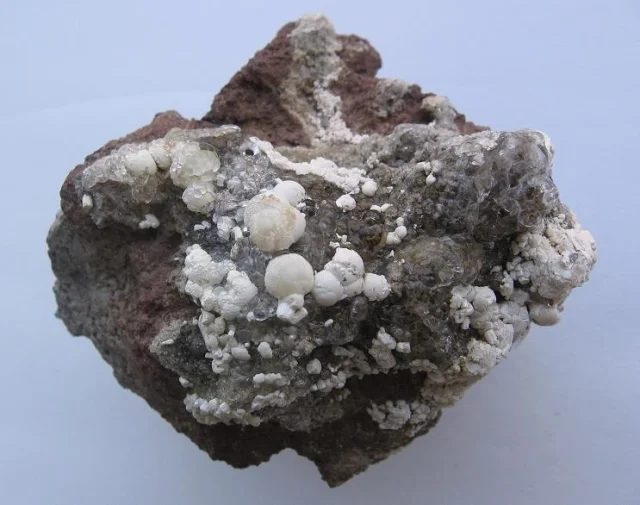 Mineral photo of Fluorapatite, Opal (var. hyalite) from locality Valeč, Czech Republic