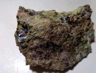 Mineral photo of Grossular (var. hessonite), Hematite from locality Mirošov, Czech Republic