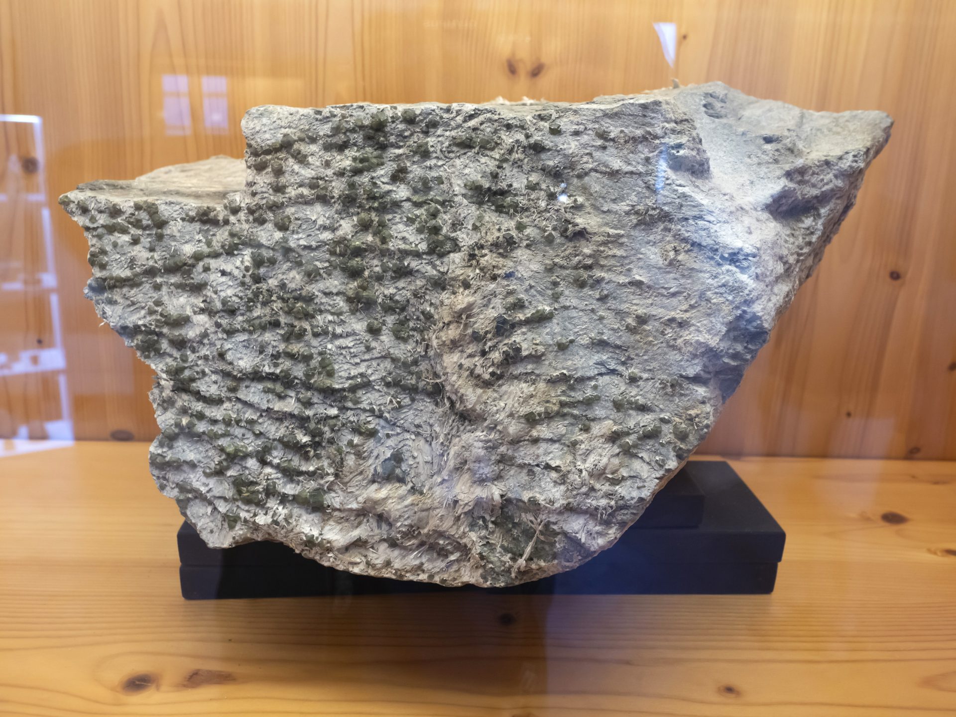 Mineral photo of Andradite (var. demantoid), Chrysotile (var. asbestos) from locality Sferlùn asbestos mine, Lanzada, Sondrio Province, Lombardy, Italy